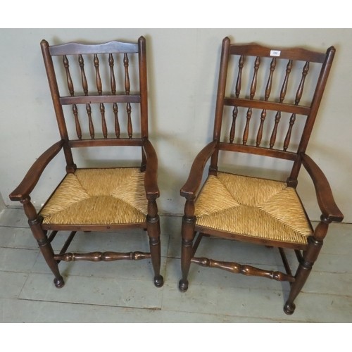 879 - A set of eight (6 + 2) Georgian style Lancashire oak framed spindle back rush seated dining chairs.
... 