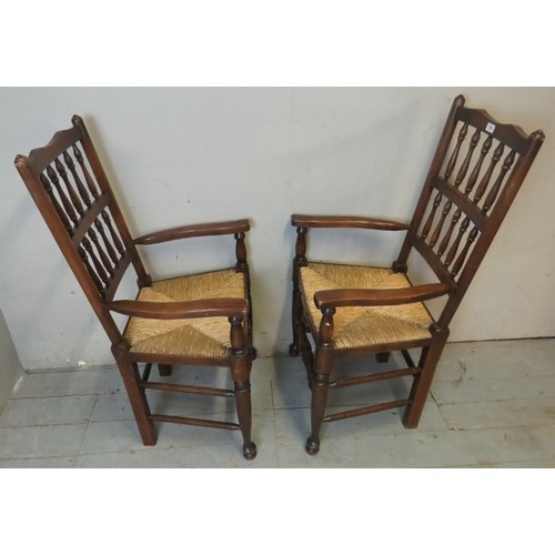 879 - A set of eight (6 + 2) Georgian style Lancashire oak framed spindle back rush seated dining chairs.
... 