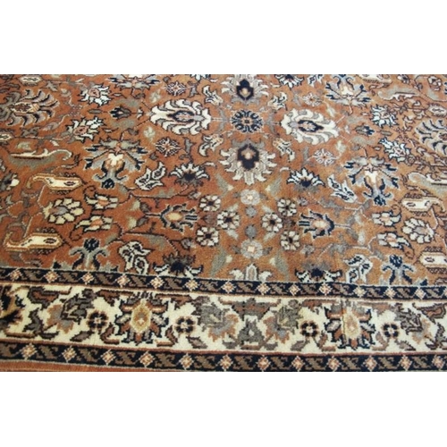 926 - A 20th century rug, a central pattern field on dusky pink ground with a patterned cream border. 205c... 