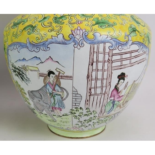 104 - A pair of Chinese Cantonese enamel vases hand decorated with traditional scenes set on a yellow back... 