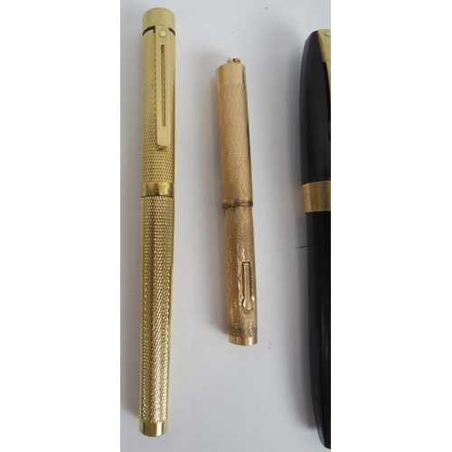 115C - A gold plated Shaeffer fountain pen, a Wahl gold plated small fountain pen, a black Shaeffer fountai... 