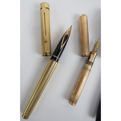 115C - A gold plated Shaeffer fountain pen, a Wahl gold plated small fountain pen, a black Shaeffer fountai... 