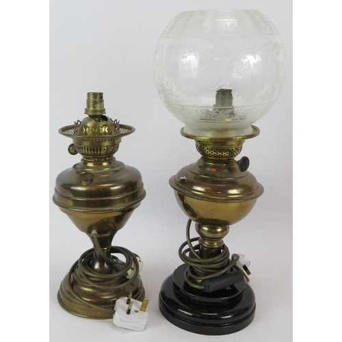 123 - Two brass oil lamps, both etched Cranberry shades and two similar lamps converted to electricity, on... 