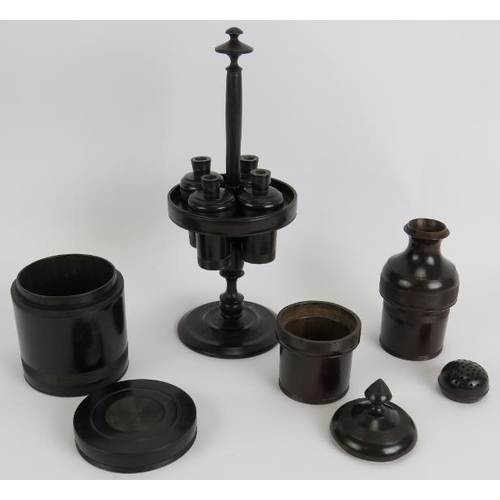 128 - A four piece antique turned ebony gentleman's toilet set including stand with four containers, two l... 