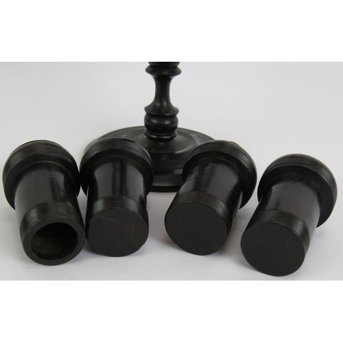 128 - A four piece antique turned ebony gentleman's toilet set including stand with four containers, two l... 