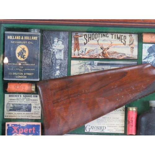 129 - A cased montage of shooting related collectables including a shotgun stock, hip flask, labels, photo... 