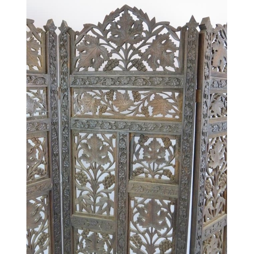 131 - A four panel carved hardwood Indo-Persian screen with intricate grape and vine panels. Height 79cm.
... 