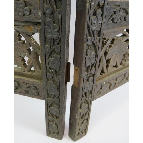 131 - A four panel carved hardwood Indo-Persian screen with intricate grape and vine panels. Height 79cm.
... 