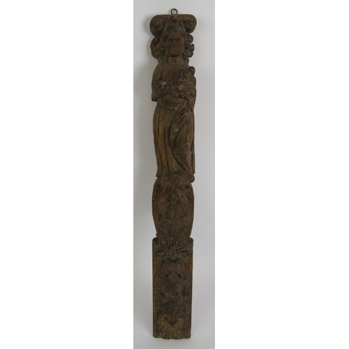 136 - An antique carved oak caryatid of robed figure, probably 17th/18th century. Height 58cm. Width 7.5cm... 