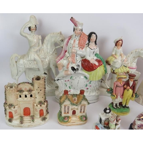 137 - Twelve antique Staffordshire pottery figures including a pair of lustre spaniels, two brightly decor... 