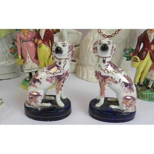 137 - Twelve antique Staffordshire pottery figures including a pair of lustre spaniels, two brightly decor... 