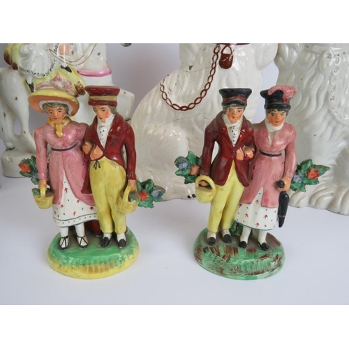 137 - Twelve antique Staffordshire pottery figures including a pair of lustre spaniels, two brightly decor... 