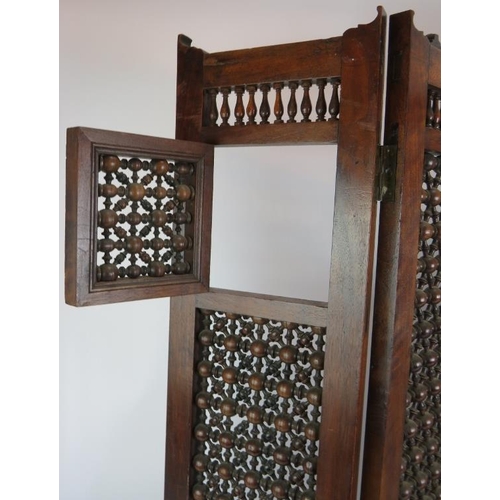 144 - A four fold North African hardwood screen with bobbin turned lattice work. Height 88cm.
Condition re... 