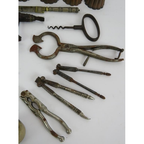 149 - Six antique copper jelly moulds, three antique corkscrews, a brass crimper, biscuit cutters, Eastern... 