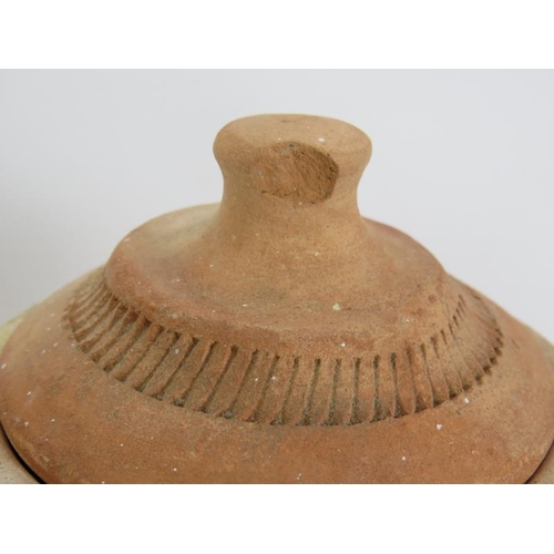 153 - A lidded terracotta amphora with internal drain. Height 34cm.
Condition report: Chip to lid finial.