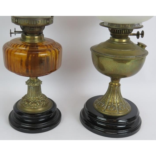 161 - Two antique oil lamps, one with amber reservoir and etched globe shade, the other with brass reservo... 