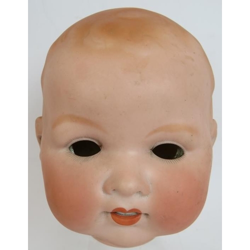 179 - A large antique Armand Marseille Bisque doll's head marked AM Germany 351/10 K and a composite doll'... 