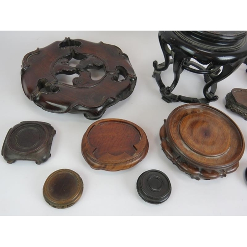 19 - 13 Chinese carved hardwood stands of various sizes and woods. Largest 31cm diameter. (13).
Condition... 