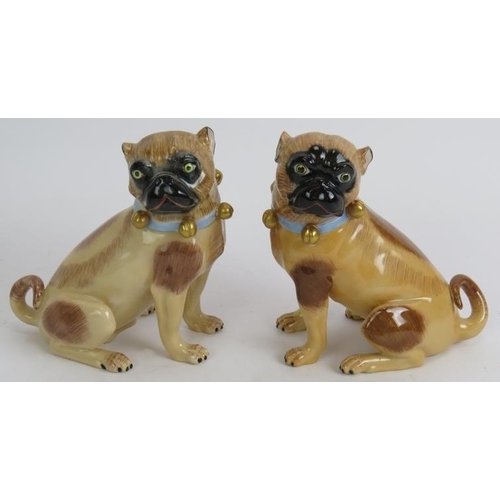 20 - A pair of Dresden porcelain pug dog figures, hand decorated and marked, and a Wallenderfer German po... 