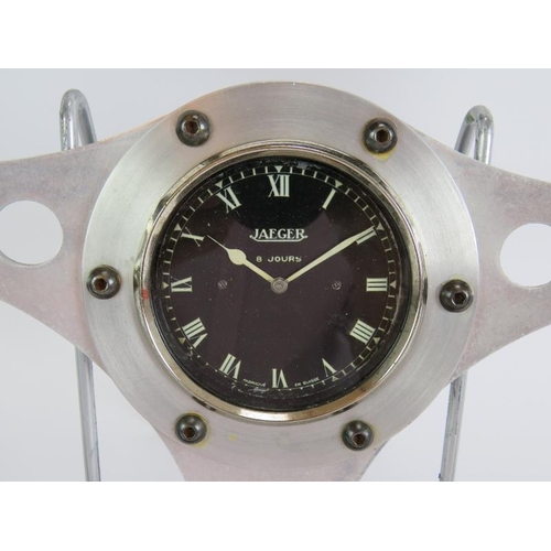 21 - A vintage Jaeger mechanical dashboard clock mounted in a 1960s alloy and stitched leather GT steerin... 