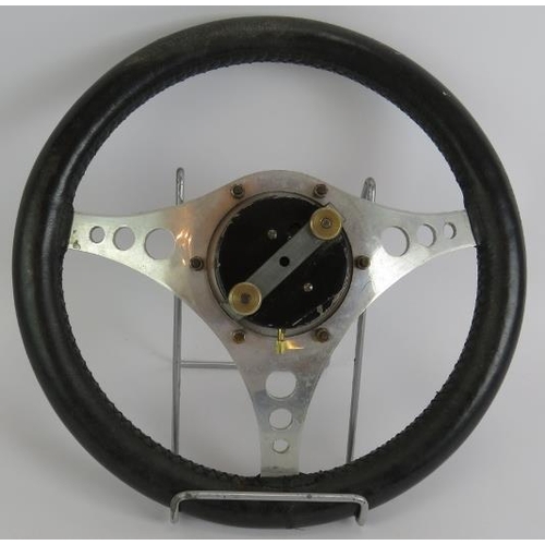 21 - A vintage Jaeger mechanical dashboard clock mounted in a 1960s alloy and stitched leather GT steerin... 