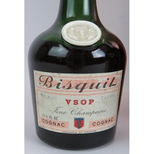 212 - A litre bottle of Courvoisier 3 star cognac, a vintage bottle of Remy Martin Vsop Cognac and a vinta... 