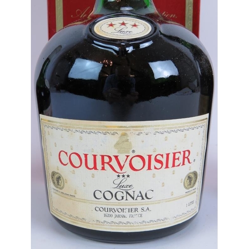 212 - A litre bottle of Courvoisier 3 star cognac, a vintage bottle of Remy Martin Vsop Cognac and a vinta... 