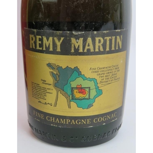 212 - A litre bottle of Courvoisier 3 star cognac, a vintage bottle of Remy Martin Vsop Cognac and a vinta... 