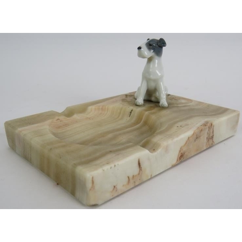 218 - An Art Deco style onyx ashtray with porcelain terrier mount. 15cm x 10cm.
Condition report: No issue... 