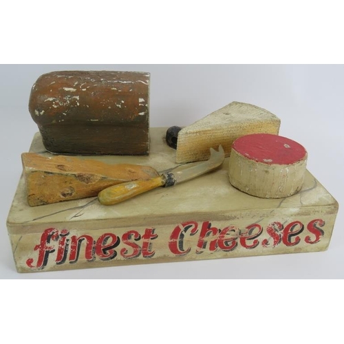 22 - A vintage 1950s shop display cheese board constructed of hand painted wood and sign written 'Finest ... 