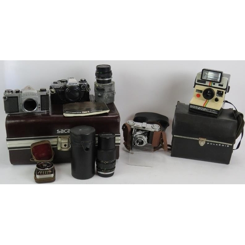 234 - An Olympus OM10 35mm camera with 18mm and 75mm-150mm lenses, a Pentaz S1A camera body, light meter, ... 