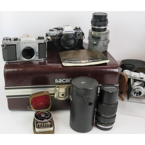 234 - An Olympus OM10 35mm camera with 18mm and 75mm-150mm lenses, a Pentaz S1A camera body, light meter, ... 