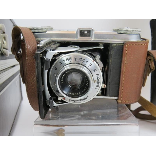 234 - An Olympus OM10 35mm camera with 18mm and 75mm-150mm lenses, a Pentaz S1A camera body, light meter, ... 