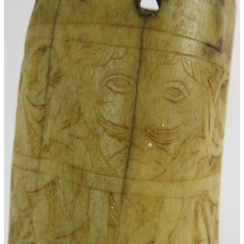 24 - A 16th/17th century scrimshaw decorated antler powder flask, probably German. Intricately carved wit... 