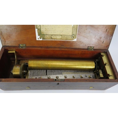 35 - An antique Swiss music box with brass and steel mechanism in an inlaid rosewood veneer case. 45cm x ... 