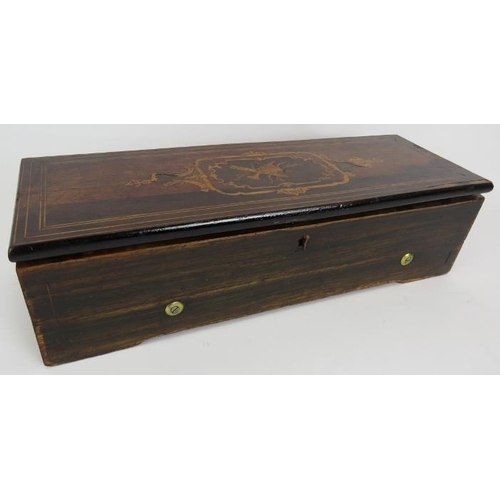 35 - An antique Swiss music box with brass and steel mechanism in an inlaid rosewood veneer case. 45cm x ... 