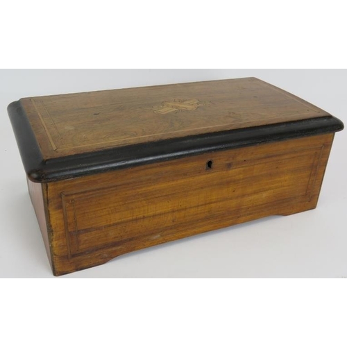 38 - A small antique Swiss music box with lever wind mechanism original label and inlaid case. 35cm x 19c... 