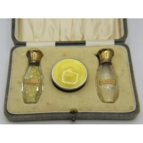 381 - A lovely silver gilt & enamelled perfume and compact set comprising of two silver & enamelled top pe... 