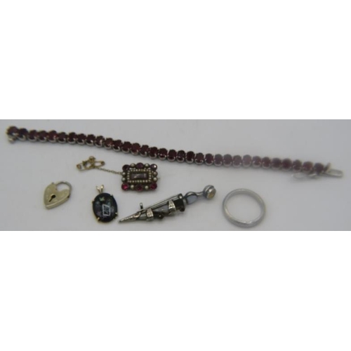 391 - A white metal garnet bracelet with indistinct marks on the clasp, the 33 garnets are approx 7mm x 5m... 