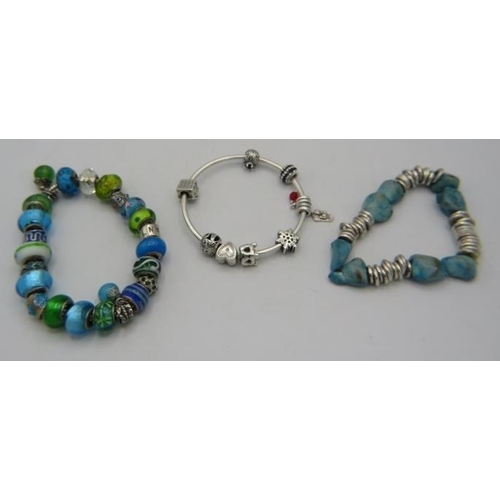 398 - A collection of three Pandora bracelets to include one with beads and one with nine charms, all boxe... 