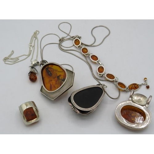 408 - A collection of amber jewellery to include two large pendants marked 925 & on 925 marked chains, a r... 