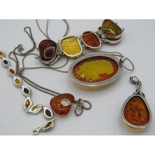 409 - Four items of amber jewellery, all marked 925 to include a heart shaped pendant on a 925 stamped cha... 