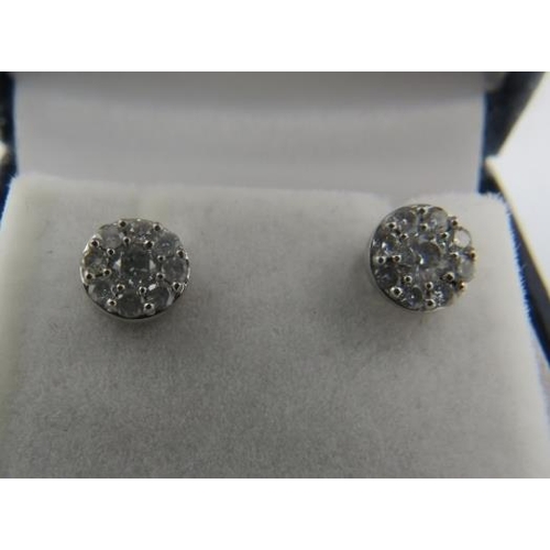 417 - A pair of 10ct white gold round brilliant cut diamond halo cluster ear studs, boxed. Diamonds approx... 