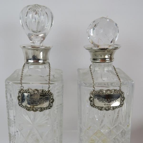 425 - A pair of cut crystal glass candlesticks, two spirit decanters, one with hallmarked silver collar, t... 