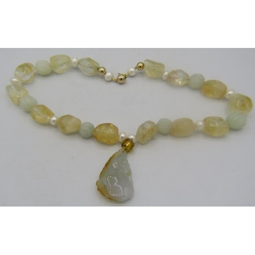 432 - A Chinese necklace made up of irregular shaped citrine stones & baroque pearls with a jade pendant i... 