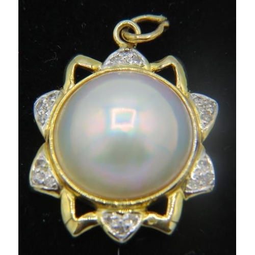 436 - An unmarked yellow metal star shaped diamond and mabe pearl pendant. The centre mabe pearl surrounde... 