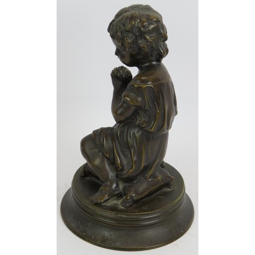 44 - A small European bronze figure of a praying child kneeling on a cushion. Unsigned. Height 23cm.
Cond... 