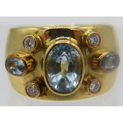 440 - A heavy 18ct yellow gold wide banded ring set with aquamarines & diamonds. Centre aquamarine approx ... 