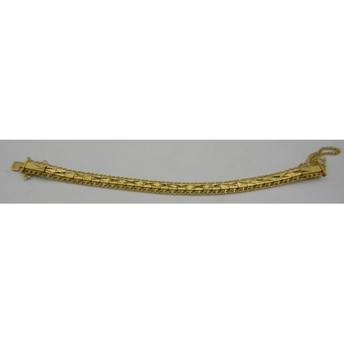 447 - A heavy 14ct yellow gold jointed bracelet with X design and safety chain, boxed. Approx weight 25.6 ... 