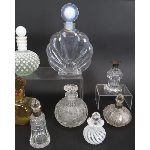 45 - A collection of ten glass scent bottles, two with silver mounts, five cut glass and one signed. Tall... 